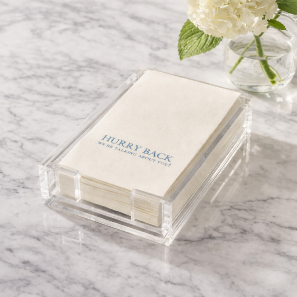 Stack of cards with text on a marble surface with flowers in the background