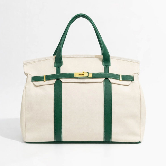 White tote bag with green straps and trim on a white background