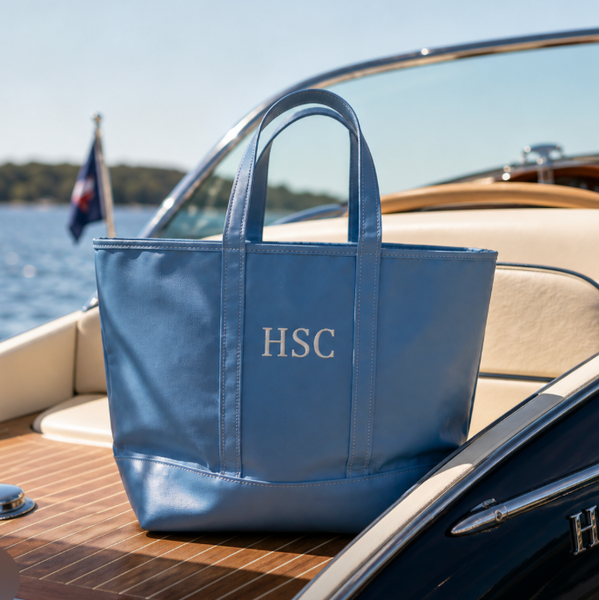 Blue tote bag with 'HSC' monogram on a boat