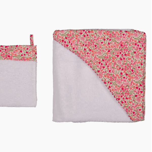 Floral-patterned baby blanket and pouch on a white background