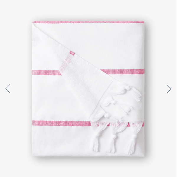 White towel with pink trim on a white background