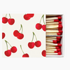 Matchbox with cherry design on the cover and matches inside.