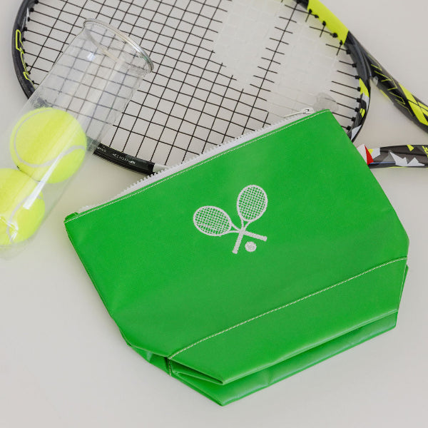 Tennis racket with green case and balls on a light gray background