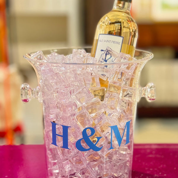 Wine bottle in a pink ice bucket with 'H&M' logo