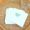 Stack of white napkins with 'FORCED FAMILY FUN' text on a woven placemat.